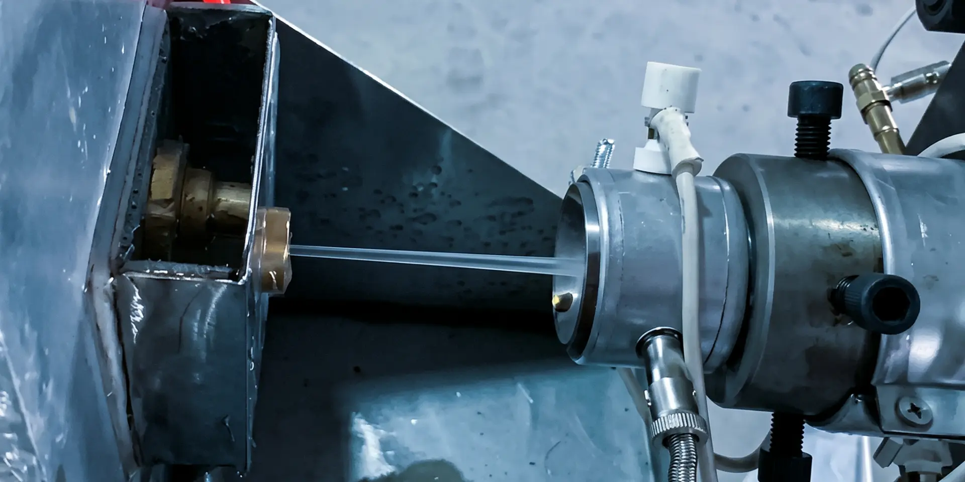 Extrusion tube entering a vacuum tank after passing through die tooling
