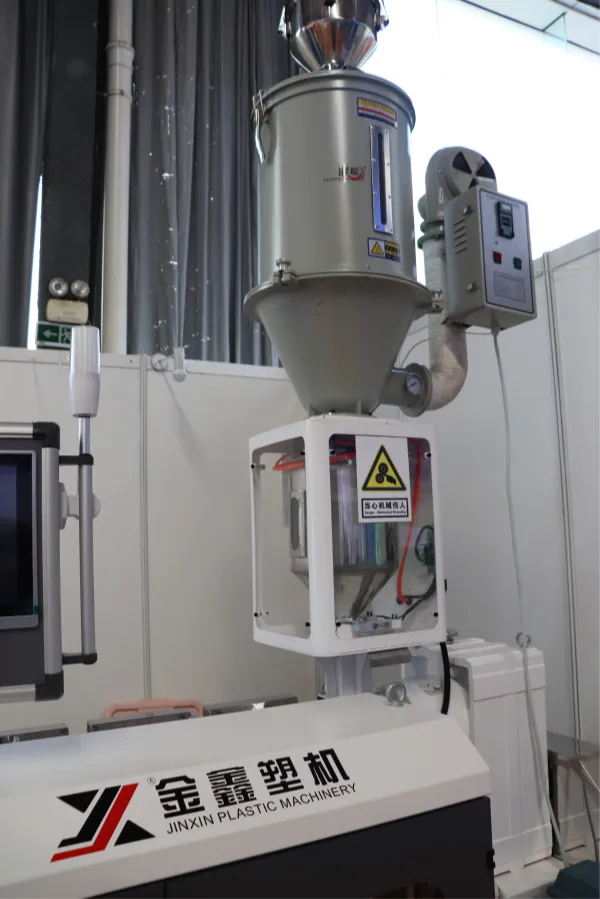 Extruder hopper feeding plastic resin into the barrel for stable plastic extrusion input