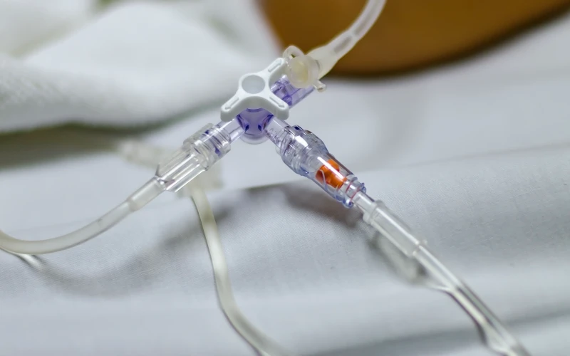 Clear soft PVC infusion tubing shown within an IV application assembly