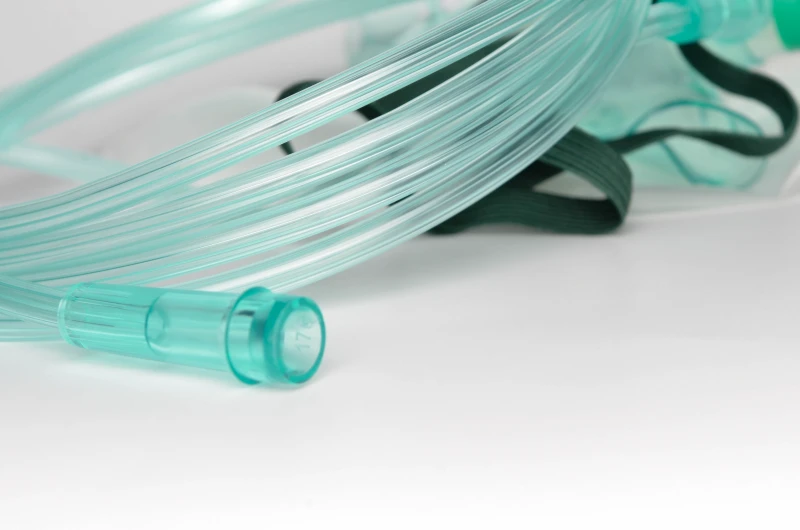 Smooth green soft PVC oxygen tubing shown in a respiratory application