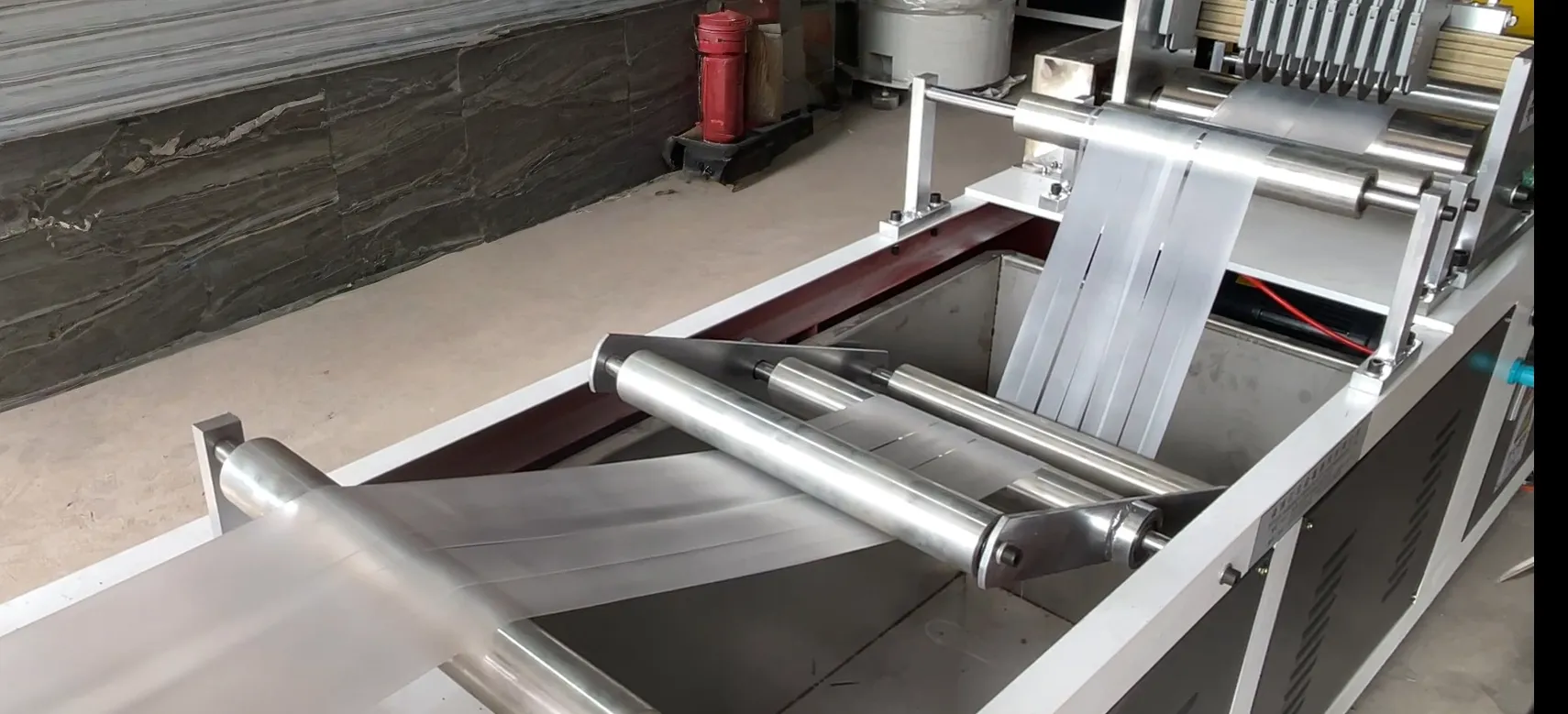 Transparent TPE medical bands being slit on a TPE tourniquet extrusion line for tourniquet and Esmarch bandage production