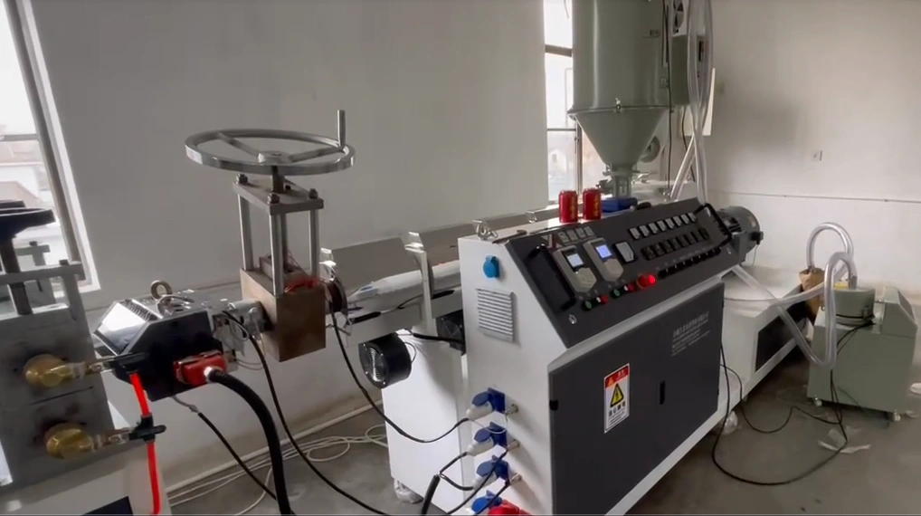 Main extruder and die area operating on a TPE tourniquet extrusion line for flat elastic band production