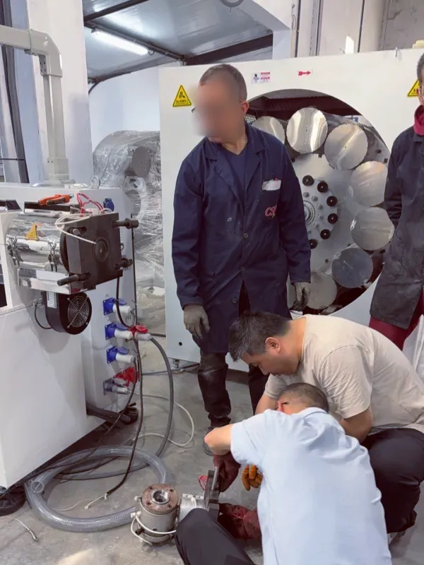 Jason Shen and Jinxin engineers disassembling and cleaning extrusion die tooling